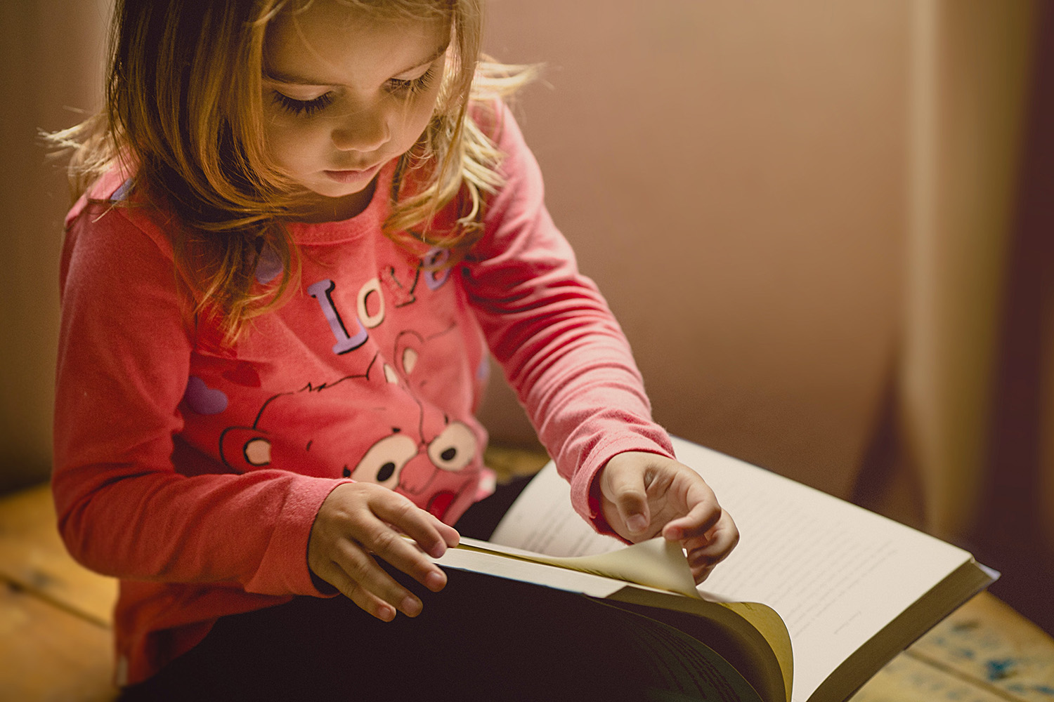 Little girl reading to herself
